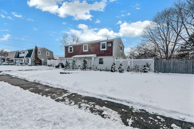 view of snow covered rear of property