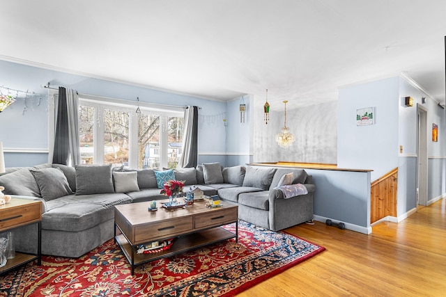 living room with crown molding and light hardwood / wood-style floors