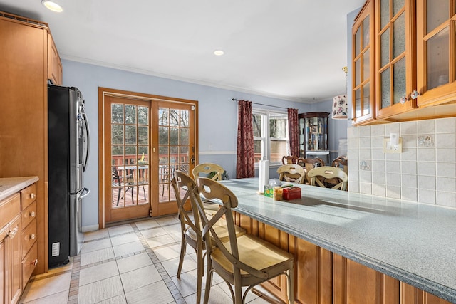 dining space with light tile patterned flooring and a wealth of natural light