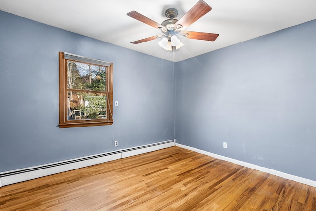 empty room with ceiling fan, a baseboard heating unit, and light hardwood / wood-style floors