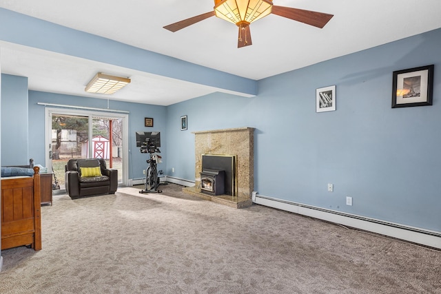 carpeted living room featuring a wood stove, beamed ceiling, ceiling fan, and a baseboard heating unit