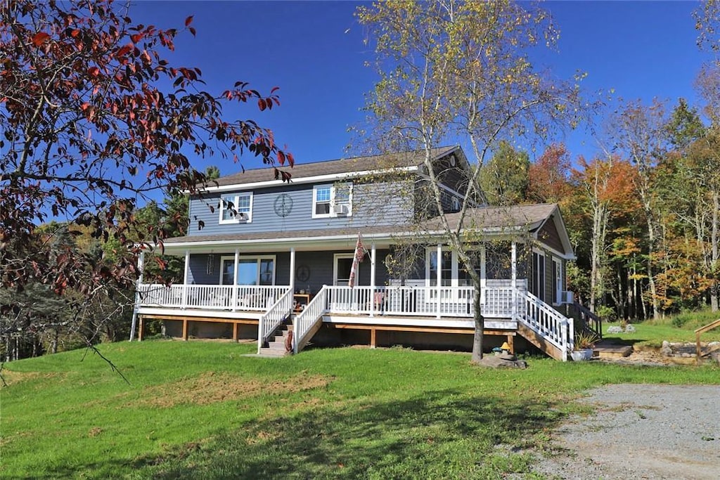 view of front of property featuring covered porch and a front yard