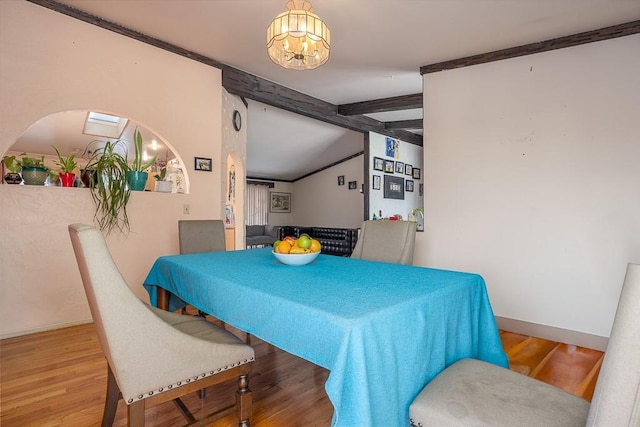 75 Tennyson Dr, Nanuet, NY 10954 - dining area with vaulted ceiling with beams, wood-type flooring, a notable chandelier, and ornamental molding