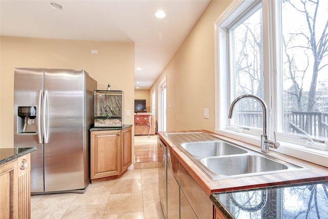 kitchen with light tile patterned floors, stainless steel appliances, and sink