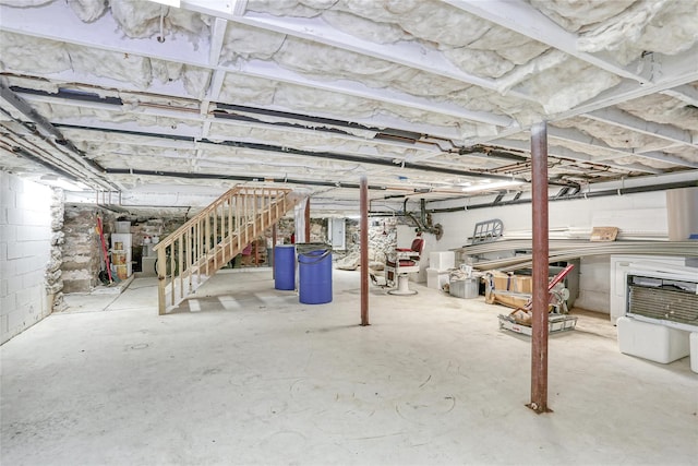 basement with electric panel and water heater