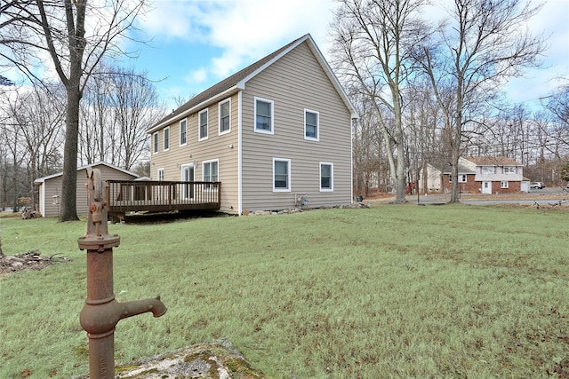 view of home's exterior featuring a deck and a lawn