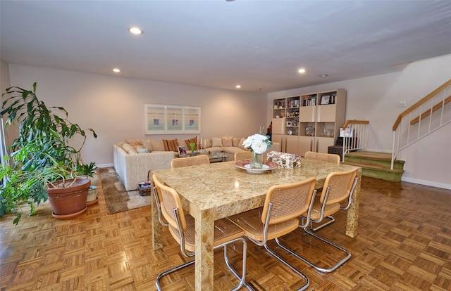 dining space with parquet flooring