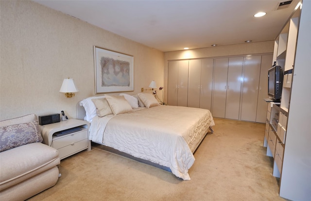 bedroom featuring light carpet and a closet