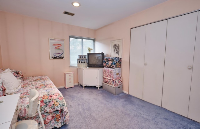 bedroom with a closet and dark colored carpet