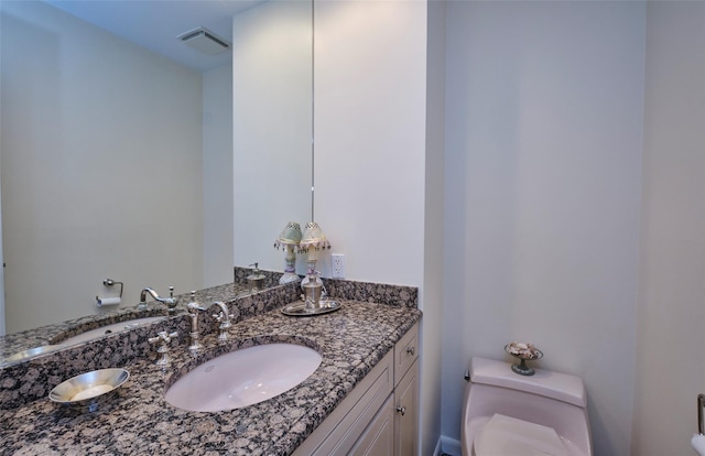 bathroom with vanity and toilet