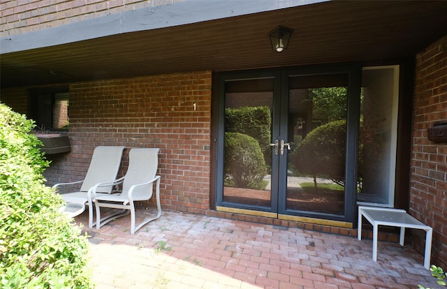 view of exterior entry with french doors and a patio