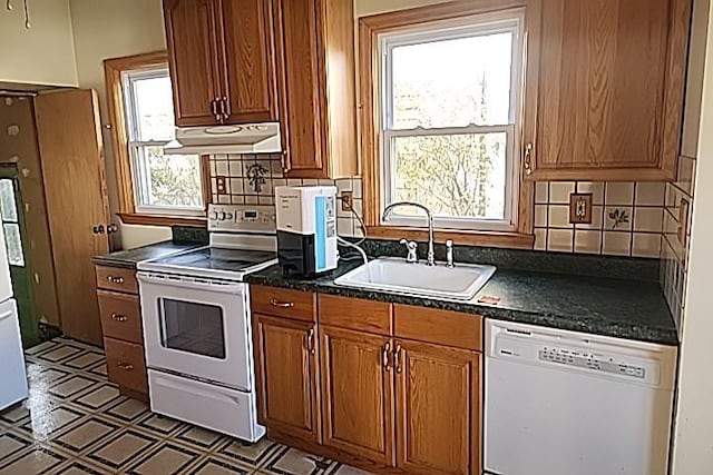 kitchen featuring white appliances, sink, and tasteful backsplash