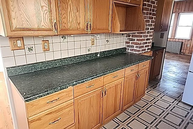 kitchen with tasteful backsplash and dark stone counters