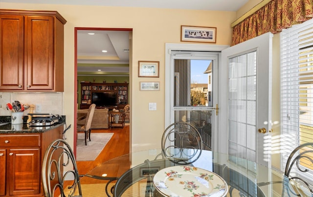 dining room with a raised ceiling and french doors