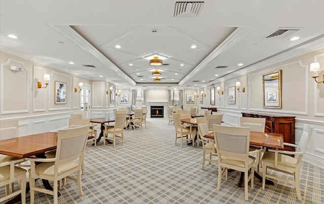 dining space with ornamental molding and a tray ceiling