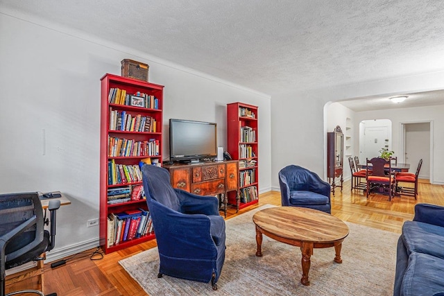 living room with a textured ceiling and parquet floors