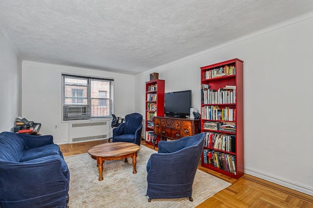 living room with parquet flooring, a textured ceiling, and radiator