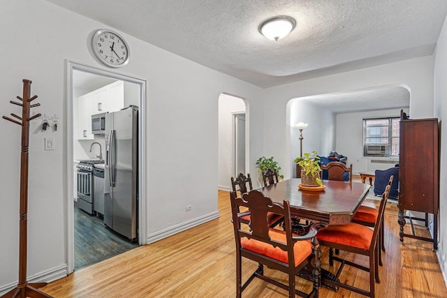 dining area featuring hardwood / wood-style floors and a textured ceiling