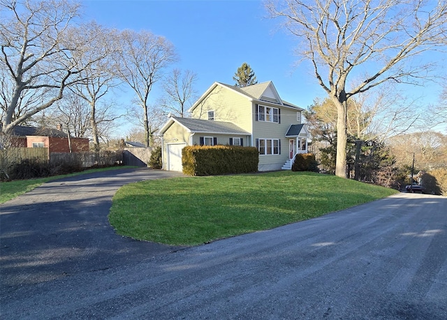 view of side of home featuring a lawn and a garage