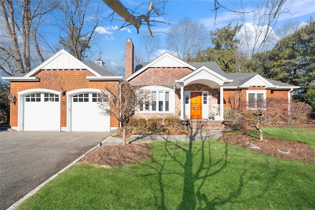 view of front of home featuring a garage and a front lawn