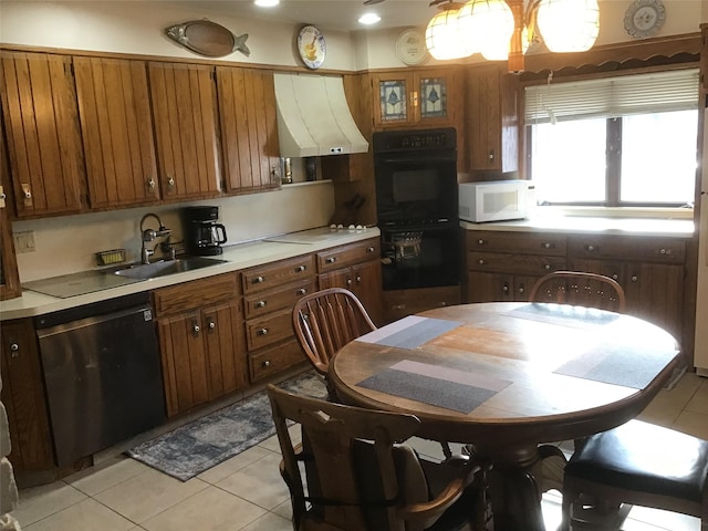 kitchen featuring sink, black double oven, dishwashing machine, light tile patterned floors, and exhaust hood