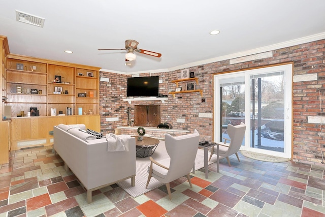 living room with brick wall, ceiling fan, and crown molding