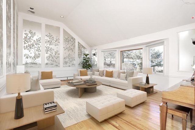 sunroom / solarium with lofted ceiling and a baseboard radiator