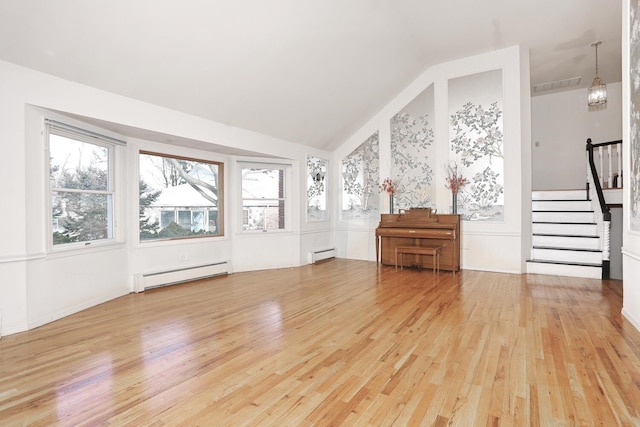 unfurnished living room featuring lofted ceiling, baseboard heating, and hardwood / wood-style floors