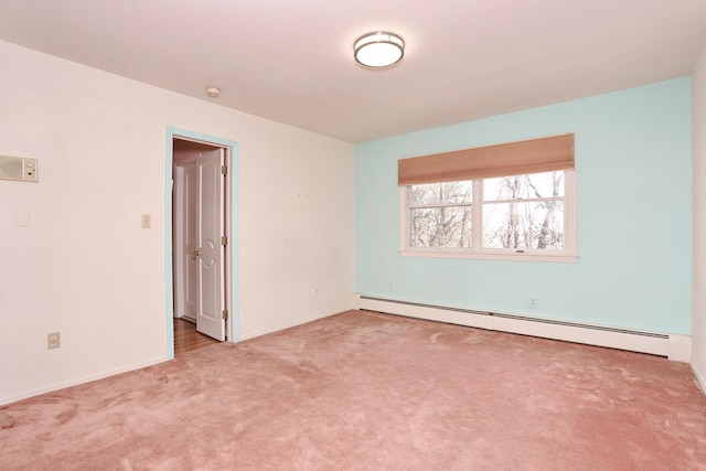 carpeted empty room featuring a baseboard radiator