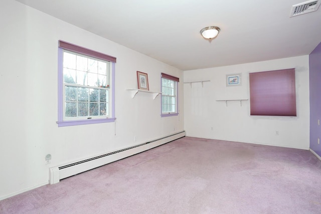 carpeted spare room with baseboard heating