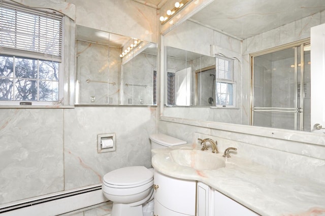 bathroom with a baseboard radiator, vanity, and toilet