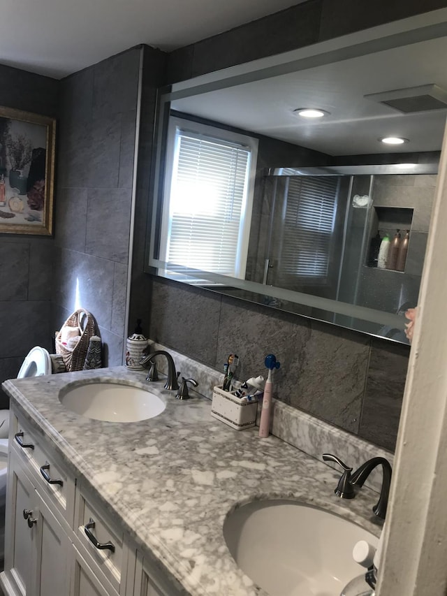 bathroom featuring backsplash, walk in shower, vanity, tile walls, and toilet