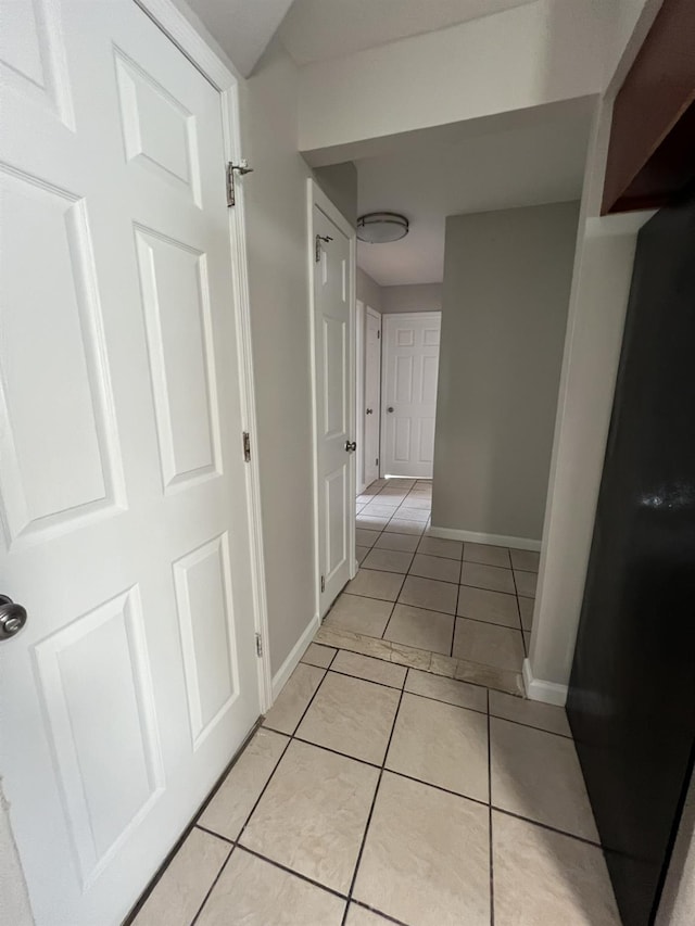 hall featuring light tile patterned floors