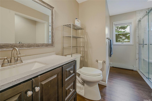 bathroom featuring vanity, a baseboard heating unit, wood-type flooring, toilet, and a shower with shower door