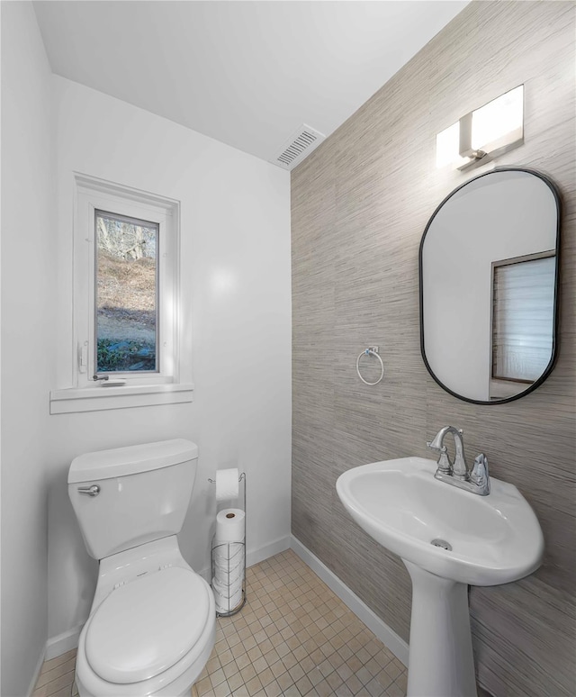 bathroom with tile patterned flooring and toilet