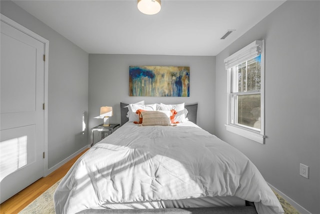 bedroom with hardwood / wood-style flooring