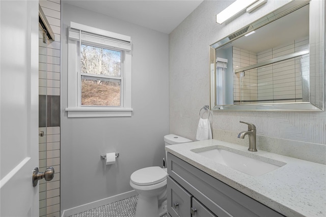 bathroom with tile patterned floors, vanity, toilet, and walk in shower