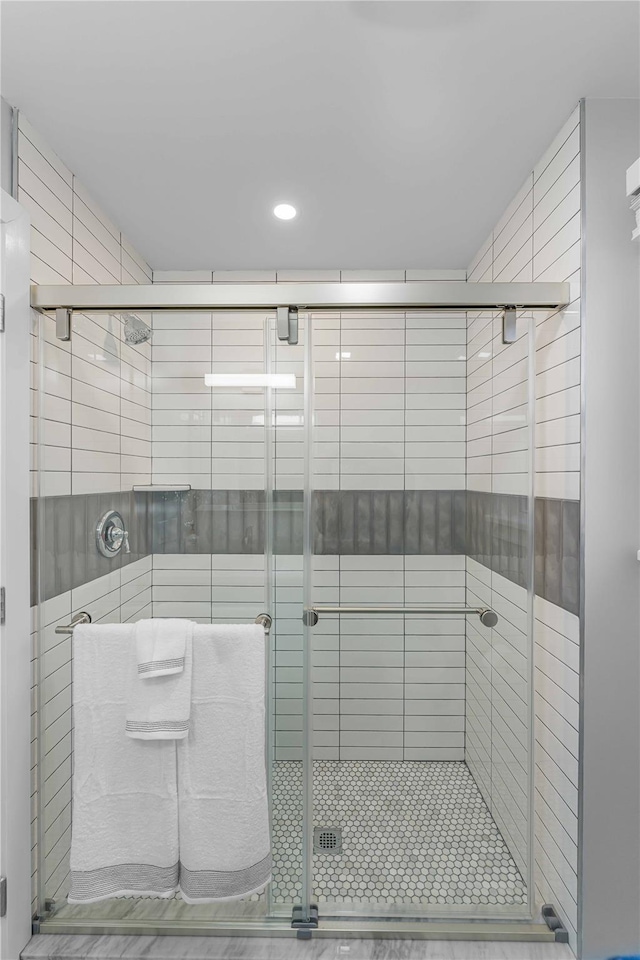 bathroom featuring a shower with door