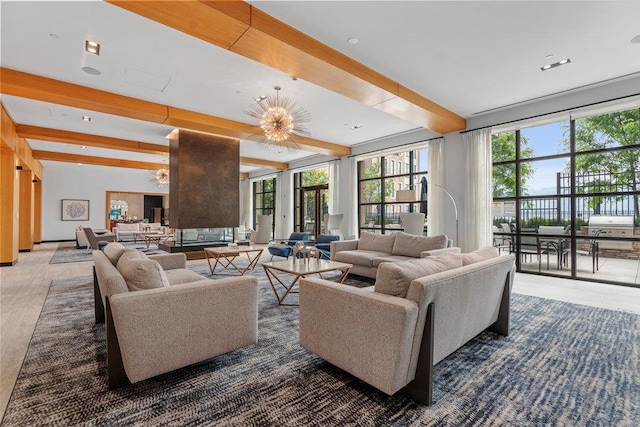 living room with beamed ceiling and a chandelier