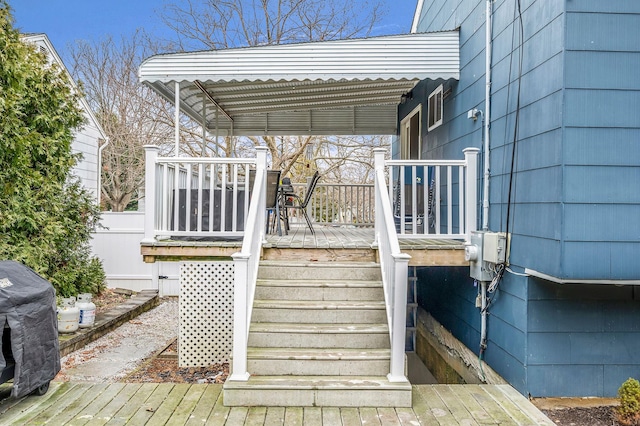 wooden terrace featuring a pergola and a grill