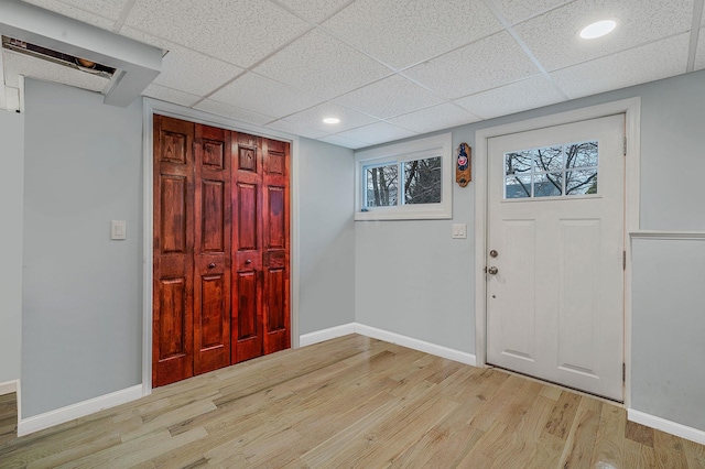 entryway with a drop ceiling and light hardwood / wood-style floors