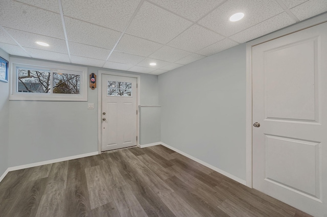 foyer entrance featuring a drop ceiling and wood-type flooring