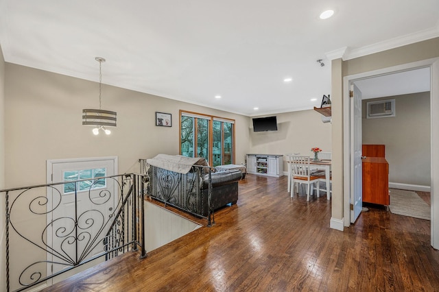 living room with ornamental molding, dark hardwood / wood-style flooring, a healthy amount of sunlight, and an inviting chandelier