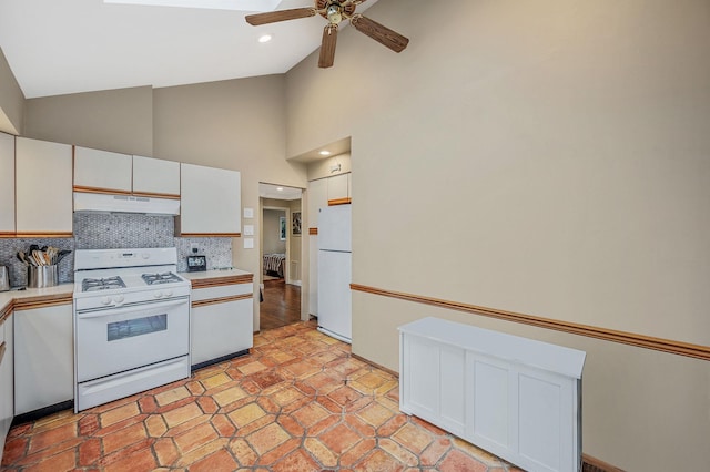 kitchen featuring white appliances, tasteful backsplash, white cabinetry, and ceiling fan