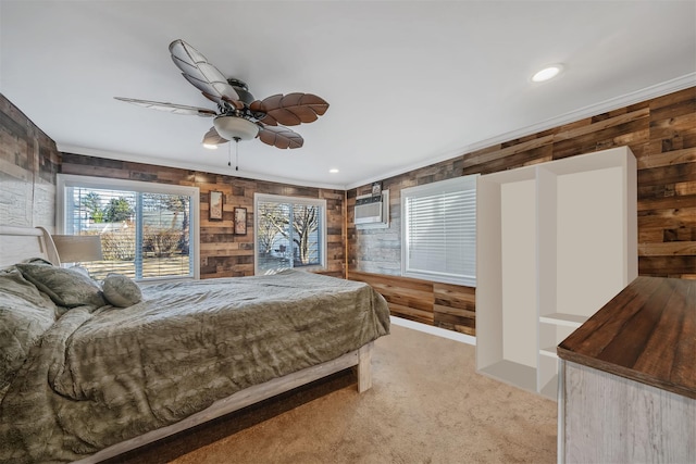 carpeted bedroom with ceiling fan, wood walls, and a wall mounted air conditioner