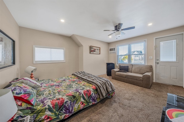 bedroom with a wall unit AC, ceiling fan, and carpet flooring