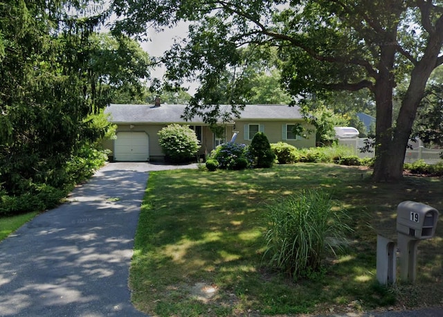 ranch-style house with a garage and a front yard