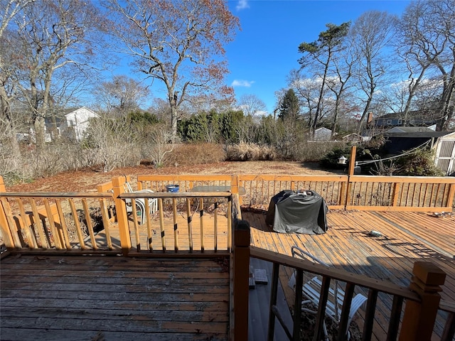 wooden terrace featuring grilling area