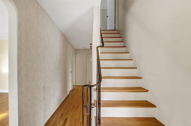 stairway featuring wood-type flooring