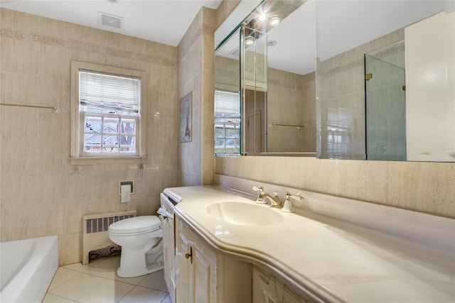 bathroom featuring radiator, a bathing tub, tile patterned flooring, vanity, and tile walls